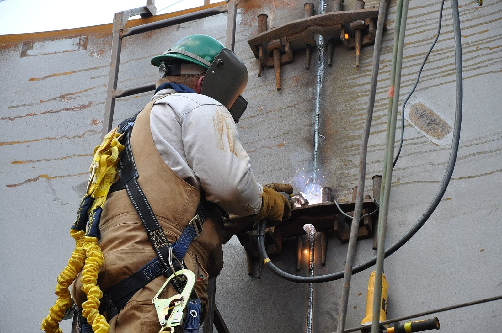 Crew welding pipework on site