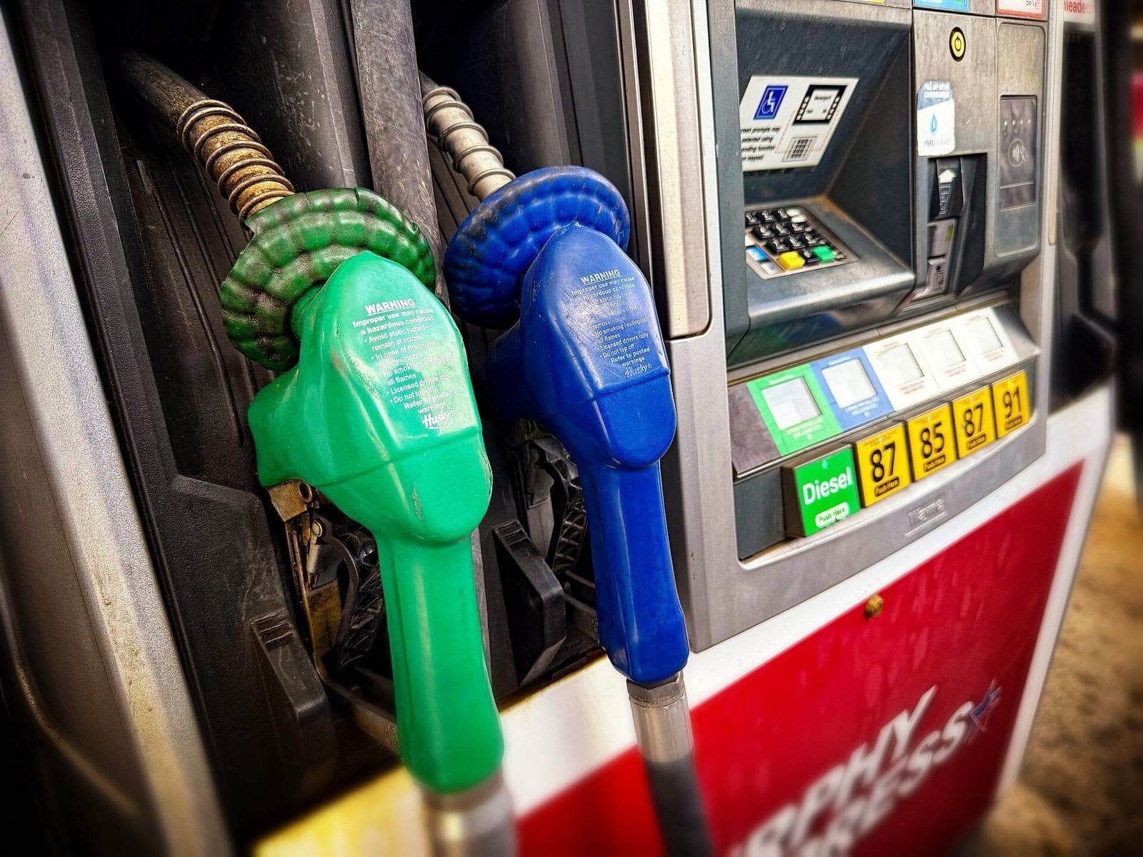 A fuel dispenser head showing the volume and price display, nozzles and payment keypad